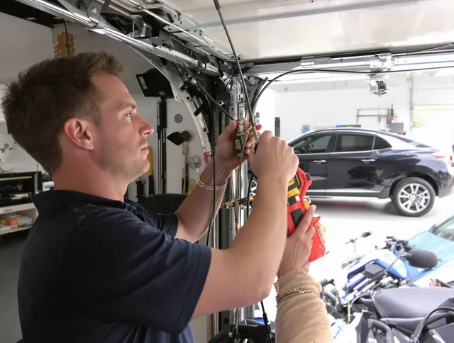 Groton Garage Door Repair safety certified technician performing cable replacement in Groton